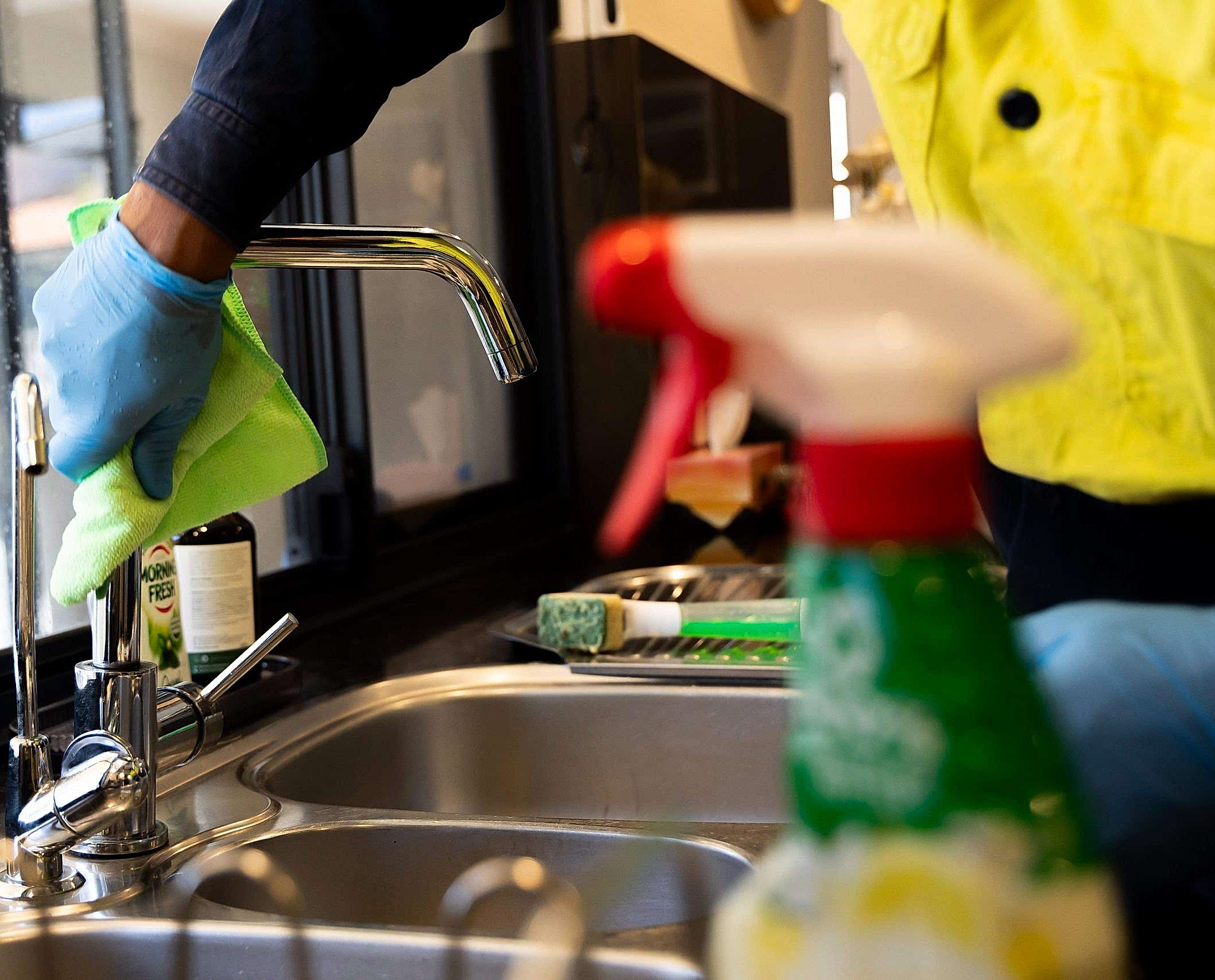 R6 2832 scaled e1702274859955 About Us 13 cleaner using a cloth on a long tap