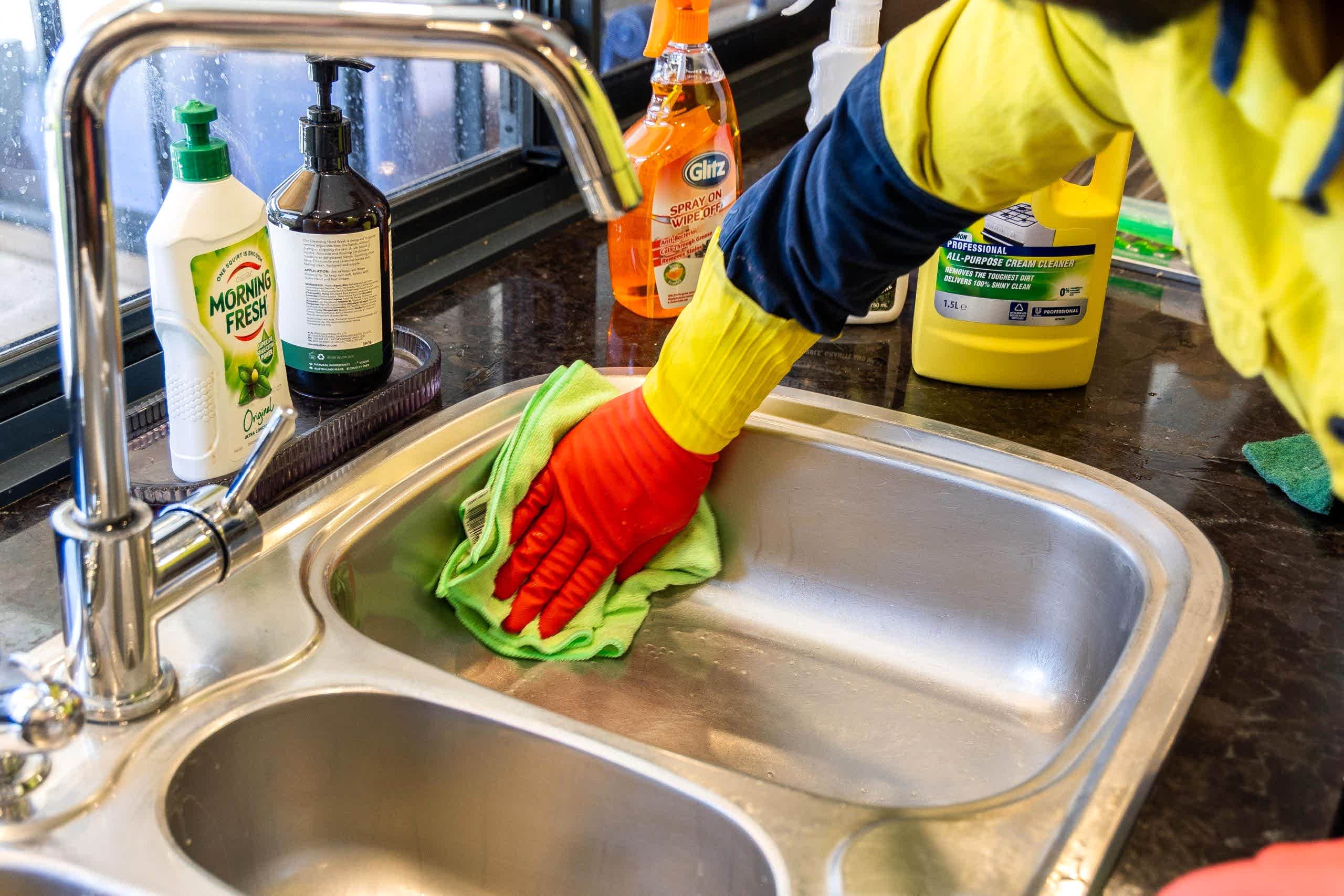 R6 3509 scaled What Makes a Cleaner Exceptional? Unveiling Expert Advice 1 cleaner scrubbing the inside of sink